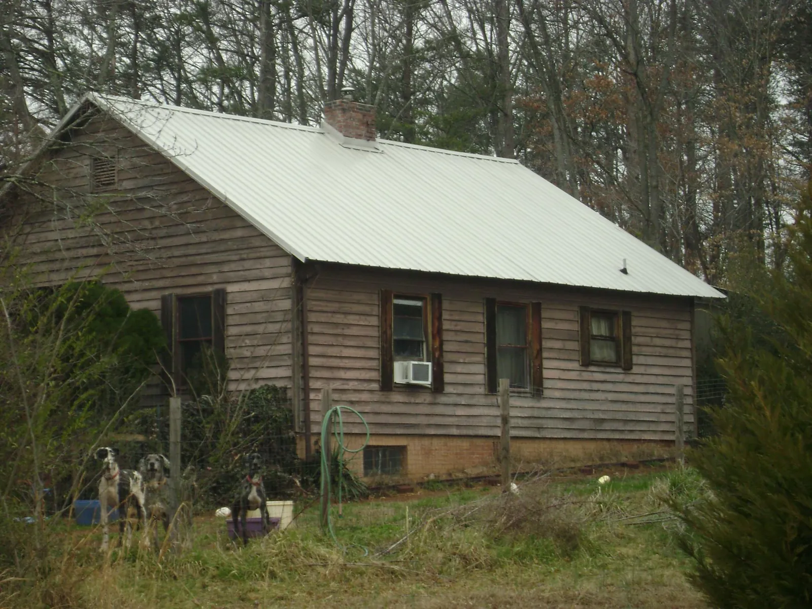 White metal roof on an old wood sided farmhouse, from a Metal Roof Installation job in Belford